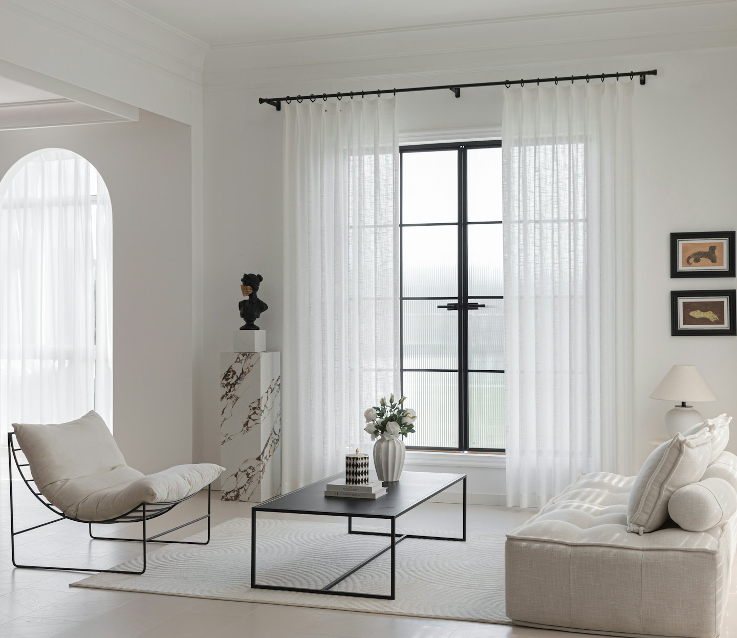 Modern living room featuring a sofa, armchair, and coffee table.
